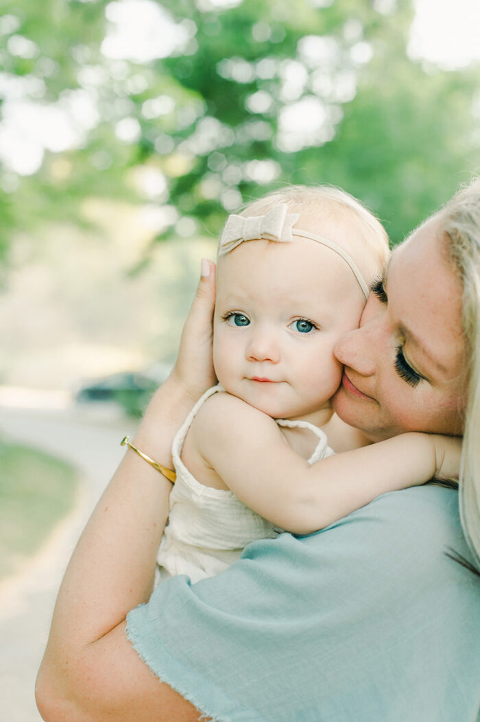 mama holds her one year old baby tight