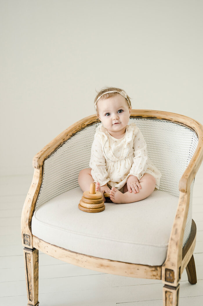 sweet baby girl sitting for her portrait